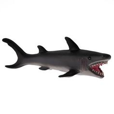 a toy shark with its mouth open on a white background