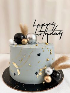 a birthday cake with gold and black decorations