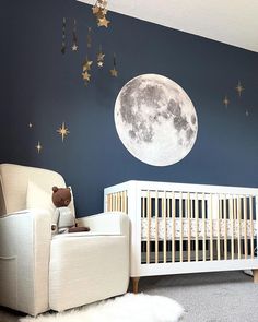 a baby's room with a moon and stars painted on the wall