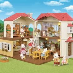 a doll house with many animals in the front yard and on the ground around it