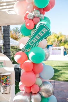 a bunch of balloons that are on top of a pole