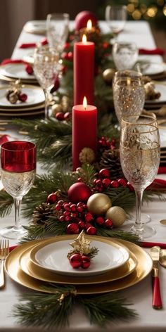 a christmas table setting with candles and plates