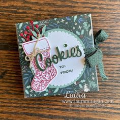 a close up of a card on a table with a bird and christmas stocking