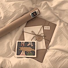 an envelope and some cards on a bed