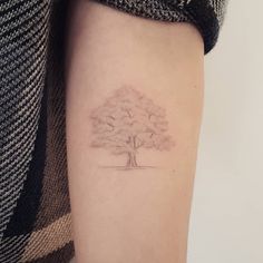 a small tree tattoo on the right arm