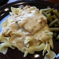 a plate with pasta, green beans and gravy on it