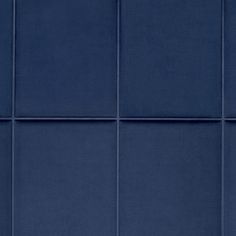 a blue tile wall with several different colors