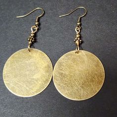 "Make a statement with these Large Bronze Tone Circle Charm Earrings. Featuring thin, lightweight charms with a flat finish and rustic scratched antiqued appearance, these disc earrings are the perfect addition to any boho or vintage-inspired look. The bronze ear wires make them easy to wear all day long, while the large size ensures they won't go unnoticed. Whether you're dressing up or keeping it casual, these earrings are sure to complement any outfit with their unique and eye-catching design Iron Jewelry, Earrings Bead, Round Dangle Earrings, Earrings Round, Small Jewelry Box, Disc Earrings, Pink Paper, Lightweight Earrings, Light Weight Earrings