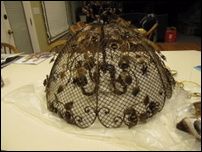 a large metal object sitting on top of a white table covered in plastic wrappers