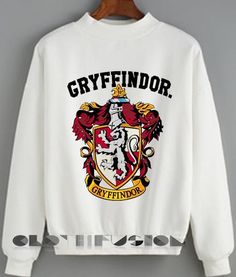 a white sweatshirt with the words greyfindor and an image of a lion on it