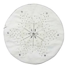 a white doily with silver sequins on it