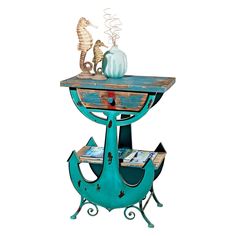 an old wooden table with seahorses on it and a vase sitting on top