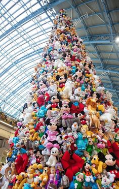 a very large christmas tree with lots of stuffed animals on it