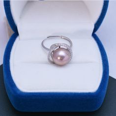 Make a statement with the 11-12mm Freshwater Pearl & Rose Ring from House of Pearls. This eye-catching ring features a luminous freshwater pearl in hues of pink and rose, encircled by polished silver. Its timeless design allows you to wear it both day and night, adding an elegant touch to your look. Whether it’s a special occasion or a casual everyday look, the 11-12mm Freshwater Pearl & Rose Ring will elevate your style with grace and charm. 11-12mm Freshwater Pearl This popular ring design fea Pink Pearl Ring For Wedding, Elegant Pink Pearl Round Ring, Button Pearl Earrings, Baroque Pearls Necklace, Pearl Jewelry Ring, Pearl Rings, Golden South Sea Pearls, Popular Rings, Pearl Rose