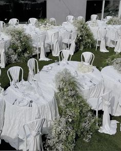 tables and chairs covered in white linens are set outside