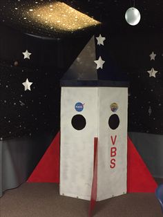 a space shuttle themed room with stars on the ceiling and red carpeted flooring