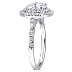 a white gold engagement ring with an oval center surrounded by round diamonds