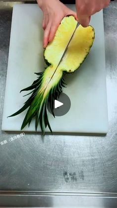 someone cutting up a pineapple on top of a white plate