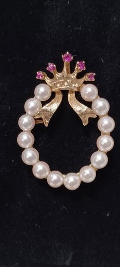 MCM Vintage Estate 14k Yellow Gold White Pearl Wreath with a Ruby Crown and Ribbon Brooch/Pendant This piece is delicate, classic, speaks volumes, is in wonderful condition and will make a great gift for that special someone.  (Remember you are a special someone also.) The brooch/pendant has a round safety catch closure, measures approximately 1 1/2 inches long, approximately an inch wide and weighs approximately 7 grams. The crown is inset with 5 round faceted rubies weighing .17 carats    The wreath consists of 14 4.5-5 mm white cultured pearls  The piece is stamped Lj, with a star above the j, and 14k Can also be turned into a pendant, be aware, the the pin closure will be visible. THE NECKLACE CHAIN IS NOT INCLUDED IN THE LISTING.  YOU WILL NEED TO PROVIDE YOUR OWN CHAIN TO TURN IT INT Luxury Round Brooches For Collectors, Luxury Round Collectible Brooches, Luxury 14k Gold Brooch Jewelry, Classic White Gold Brooches With 17 Jewels, Elegant 14k Yellow Gold Brooches, Elegant 14k Yellow Gold Brooch, Hallmarked Yellow Gold Brooches, Fine Jewelry, Hallmarked Yellow Gold Fine Jewelry Brooches, Fine Jewelry Hallmarked Yellow Gold Brooches