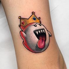 a cartoon character with a crown on it's head and tongue sticking out from its mouth