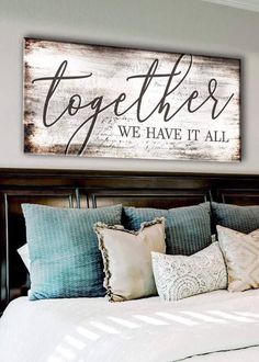 a bed sitting under a wooden sign that says together we have it all