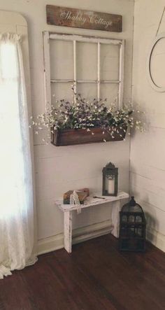 a room with a window and some flowers on the table next to a candle holder