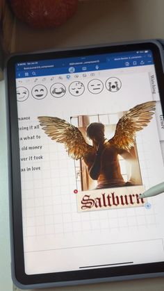 a tablet with an image of a woman's face and wings on the screen