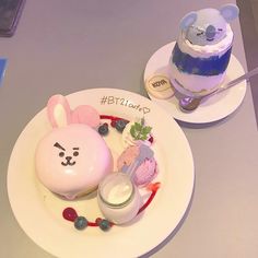 two white plates topped with desserts on top of a table next to each other