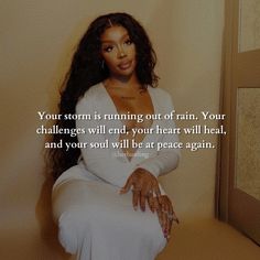 a woman sitting on top of a wooden table next to a mirror with a quote above it