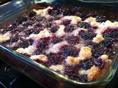 a casserole dish with blueberries and crumbs in it on the stove