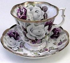 a tea cup and saucer decorated with flowers