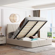 a bed with a mattress on top of it in a room next to a window