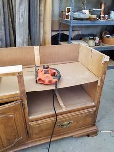 an electric sander is sitting on top of a cabinet in a shop with other tools