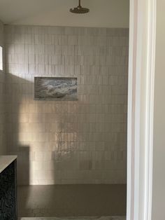 an empty bathroom with tile walls and floor