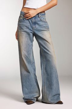 Selected pure cotton denim, made from Turkish cotton with long, glossy fibers, results in a fabric that is more skin-friendly and comfortable. The fabric has a rugged texture with prominent slub yarns in both the warp and weft. Through multiple washing and processing techniques such as enzyme washing, hand sanding, snowflake washing, and stain washing, each piece offers a unique fashionable look, embodying the texture and charm of vintage denim. The jeans feature a precisely tailored curved waistline, with custom buttons and a high-quality zip fly, emphasizing attention to detail and high quality. The brown label has a natural crinkle effect, and the irregular stain washing adds a touch of individuality. The sharp lines and sturdy construction, along with the straight-leg cut, make these j Sand Washed Jeans, Warp And Weft, Boys Fits, Denim Texture, Dream Fashion, Boy Fits, Jumpsuit Jacket, Custom Buttons, Style Jeans