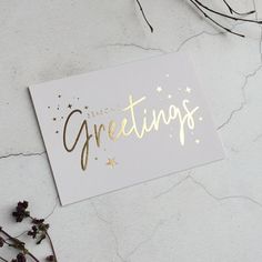 a greeting card with gold foil lettering and stars