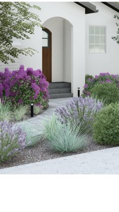 a house with purple flowers in front of it and bushes on the side of the building