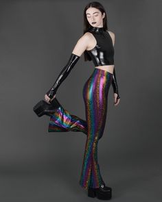 Funky sparkly holographic rainbow bell bottom leggings with high waist. These fun, futuristic, psychedelic flares are super stretchy! The perfect flared pants for any dark, disco, festival, streetwear, flow, dance wear, Burning Man, mermaidcore, glam rock, 70s, rave, hippie, robot, rocker or alt fashion colorful wardrobe! You can find the size chart in the last photo of the listing. APPROX INSEAM: XS = 33" S = 34" M = 35" L = 36"  XL = 37.5" Pictured with the Spectrum bandeau. Click here to purchase: https://www.etsy.com/listing/612357912/ This item is MADE TO ORDER. We cut and sew it after we receive your order. Fitted Pants For Halloween Party, Fitted Multicolor Bottoms For Party Season, Rave Multicolor Party Bottoms, Multicolor Rave Bottoms For Party, Rave Style Multicolor Party Bottoms, Disco Style Multicolor Party Bottoms, Iridescent Disco Bottoms For Party, Multicolor Disco Party Bottoms, Stretch Bottoms For Halloween Party