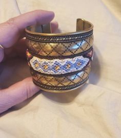 Southwestern Style, Large Brass Cuff Bracelet with Woven Fabric, Costume Jewelry, Fashion Accessory This is a nice find and very decorative.  This measures 6.75 inches long if laid flat.  This is 2 inches wide. Check out our shop for monthly specials. We have a variety of items for every taste. Combine several of our items together to save on shipping. If you have any questions, please do not hesitate to ask. I will ship outside of the US, just request a quote. Happy Shopping. I will work around Bohemian Decorative Bangle Bracelets, Bohemian Metal Bracelets With Decorative Details, Bohemian Brown Metal Cuff Bracelet, Southwestern Style Bangle Cuff Bracelet For Festivals, Multicolor Metal Bohemian Cuff Bracelet, Bohemian Multicolor Metal Cuff Bracelet, Multicolor Bohemian Metal Cuff Bracelet, Adjustable Southwestern Cuff Bracelet For Festivals, Adjustable Southwestern Style Festival Cuff Bracelet