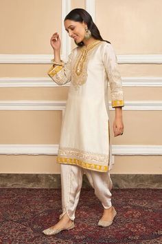 Daisy ivory short kurta with Kashmiri tilla, gota applique embroidered yoke in floral pattern. Paired with dhoti pant. - Aza Fashions Off White Bollywood Raw Silk Set, Bollywood Style Off White Raw Silk Set, Cream Traditional Drape Set For Navratri, Navratri Cream Traditional Drape Sets, Off White Raw Silk Sets For Eid, Off White Raw Silk Sets For Diwali, Traditional Cream Raw Silk Palazzo Set, Traditional Fitted Beige Palazzo Set, Fitted Beige Traditional Palazzo Set