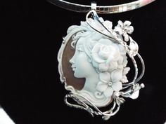 "This is a beautiful modern master hand carved sardonyx cameo by the artist, Carla. This is a very complex and intriguing piece and the design makes it an absolutely amazing piece of work. All the detail is exceptionally done to perfection! The right cameo is cameo is 48 mm mm (1.89\") and it is set into Italian silver with a 6 mm enhancer bail and a pin attachment. It comes packed in a black velvet box and certificate of authenticity for gift giving. Welcome to CASCO Cameos, LLC. CASCO Cameos i Luxury Cameo Pendant Jewelry, Elegant Carved Oval Jewelry, Elegant Oval Carved Jewelry, Luxury Cameo Medallion Jewelry, Exquisite Cameo Jewelry For Formal Occasions, Luxury Intaglio Pendant Jewelry, Elegant Carved Necklaces For Formal Occasions, Elegant Carved Necklace For Formal Occasions, Unique Sculpted Silver Jewelry