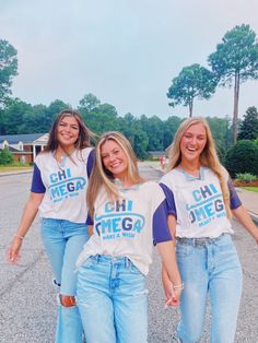 three girls are walking down the street wearing matching shirts that say chi chi chi chi