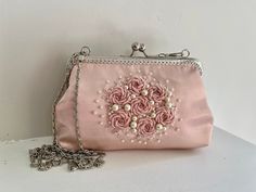 "Embroidered and lined any occasion kiss lock purse in pink satin. It comes with a metal chain if you want to carry it on your shoulder. Description Features * Women Evening Frame Clutch Bag * Materials & Colors: Pink  Satin  hand Embroidered * One main compartments * Inside, cotton lining * Kiss-lock clasp closure * Silverstone  hardware * Occasion: Wedding, Party, Banquet, Dating, Evening, Everyday Bag. * Wash Care: Dry clean only * Dimensions: Width: 25 cm / 9.8\" Height: 16 cm / 6.3\" Depth: Vintage Pink Clutch For Formal Occasions, Pink Evening Bag With Pearl Handle, Formal Pink Embroidered Evening Bag, Handmade Pink Evening Bag For Formal Occasions, Kiss Lock Purse, Satin Hands, Beautiful Museum, Purse Pink, Stylish Handbags