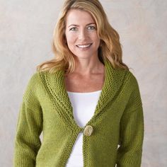 a woman wearing a green cardigan sweater and jeans