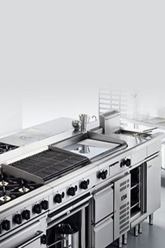 an image of a kitchen setting with stoves and ovens on the counter top