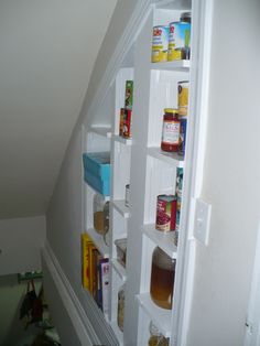 an open refrigerator door with various food items in the bottom shelf and shelves below it