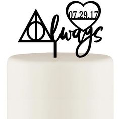 a harry potter cake topper with the hogwarts symbol