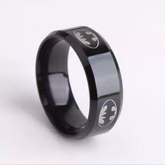 New Unisex Batman Band Ring ~ Available In Size 10 Or 11 ~ Black With Silver Batman Logo ~ Stainless Steel ~ Comfort Fit Band Measures 8mm Wide ** Batman Jewelry, Men's Jewelry, Men's Gift, Men's Batman Jewelry Batman Wedding Rings, Batman Ring, Black Band Ring, Stainless Steel Wedding Bands, Black Batman, Batman Symbol, Party Mode, Titanium Ring, Titanium Rings