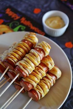 hot dogs on skewers with sauce and toothpicks