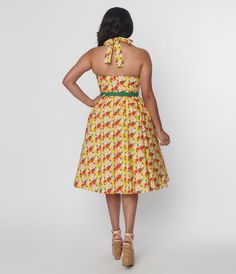 This adorable 1950s style swing dress is crafted in a smooth woven fabric that dances with charming red apples throughout the yellow backdrop. The self tie halter is framed by the sleeveless silhouette, while the full swing skirt is cinched by a red belt. Crinoline added for volume, sold separately. Available in sizes XS-5X while supplies last. Yellow Backdrop, Apple Print, Red Apples, Apple Prints, 1950s Style, Red Belt, 1950s Fashion, Red Apple, Vintage 1950s